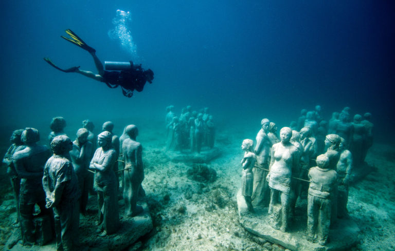 An underwater art museum, teeming with life